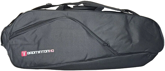 The BadmintonHQ 3 Racket Badminton Bag in black features a curved zipper pocket, top handle, and fits up to 3 rackets. "BADMINTON HQ" logo and text in white and pink are printed on the left side.
