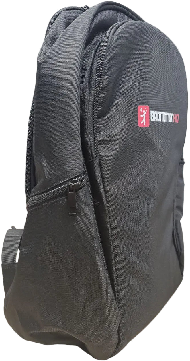 The BadmintonHQ Badminton Backpack - Black features a front zipper pocket, white and red BadmintonHQ logo, padded shoulder straps, and a rounded top, making it ideal for carrying your badminton essentials.