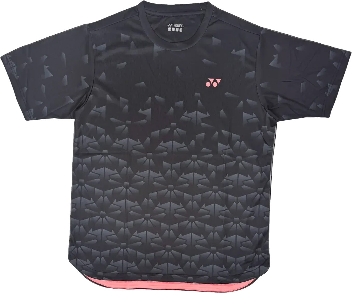 The Yonex YTM2025B Men's Badminton T-Shirt in black features a subtle geometric pattern, rounded neckline, small pink Yonex logo on the left chest, and pink fabric lining inside the bottom hem.