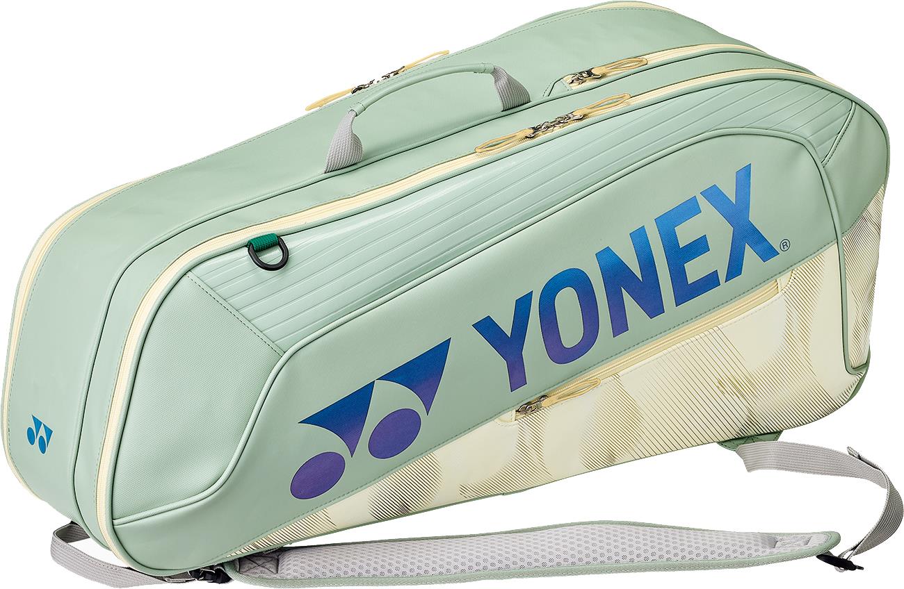 The Yonex 02626EX Expert 6 Racket Badminton Bag in Smoke Green features shoulder straps, handles, and blue-purple Yonex logo, plus Thermo Guard technology to protect your gear. Holds up to 6 rackets.