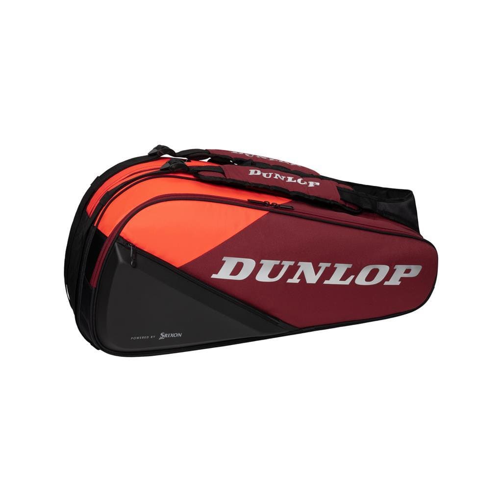 The Dunlop CX Performance 8 Badminton Racket Bag in red and black boasts multiple compartments, ergonomic shoulder straps, and prominently displays the white Dunlop logo on its side.