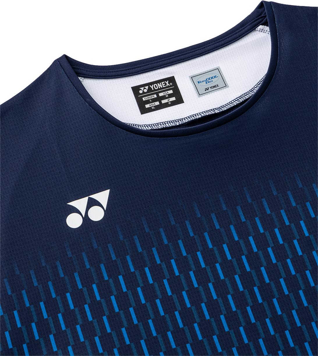Close-up of the Yonex 10713EX Crew Neck Men's Badminton T-Shirt in dark navy, featuring a geometric blue chest pattern, white Yonex logo, and visible collar label noting advanced moisture management.
