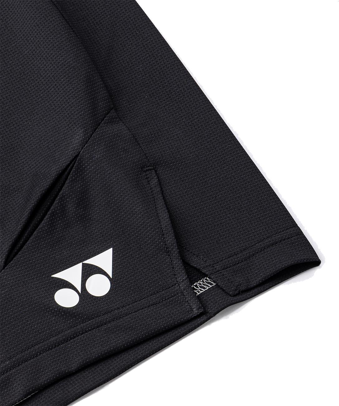 Close-up of Yonex 15239YX Knit Men's Badminton Shorts in black, featuring a white Yonex logo near the lower left seam and pocket. The breathable, textured fabric makes these shorts ideal for lightweight comfort on court.