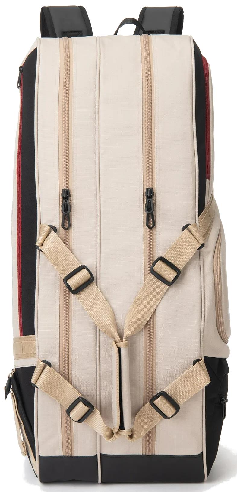 The Yonex BA72626EX Gearlogic 6 Racket Badminton Bag in beige features two vertical zippers, tan adjustable straps, black padded shoulder straps, red side accents, a visible side pocket, and is made from recycled polyester.