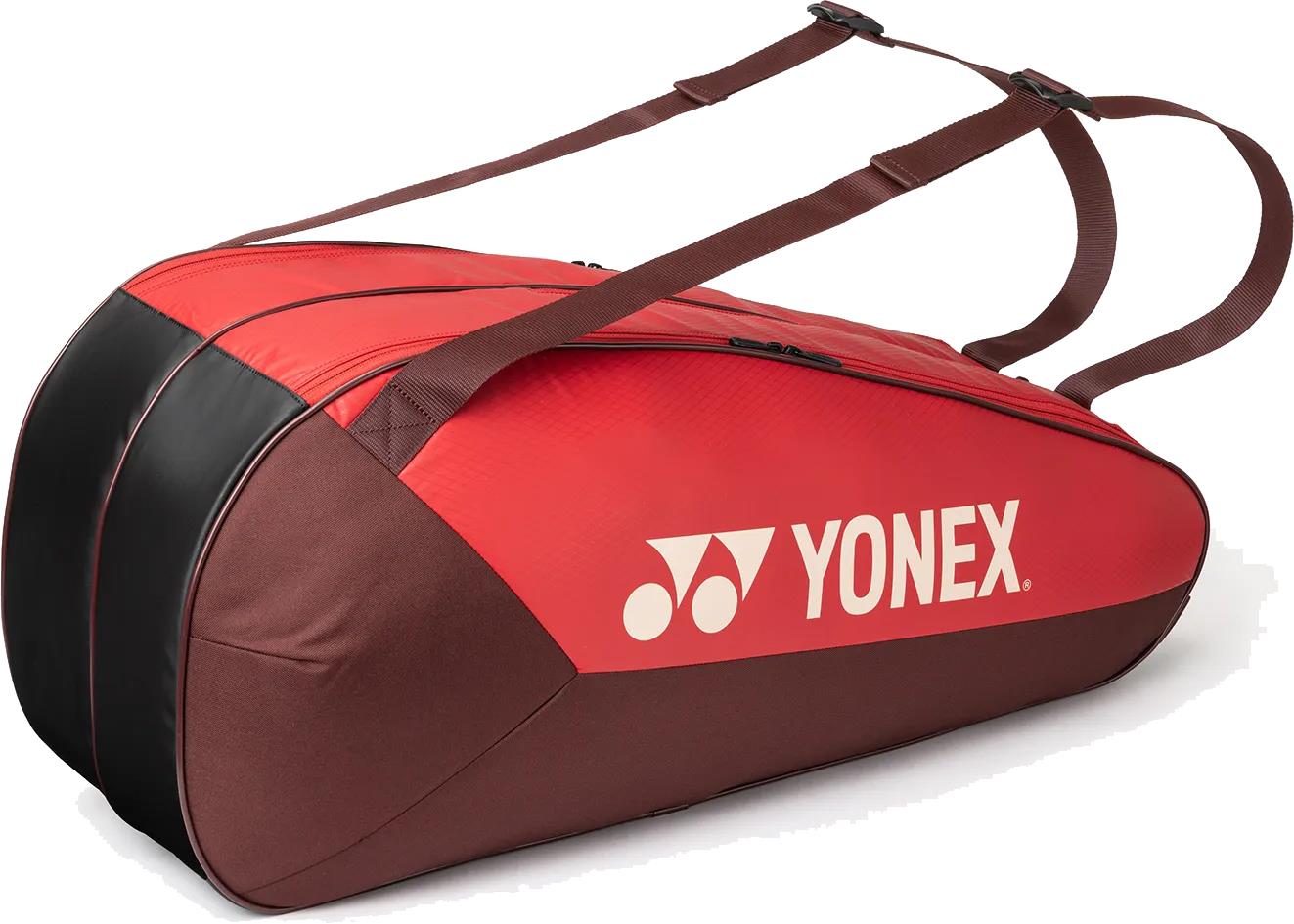 The Yonex 42526EX Team 6 Racket Badminton Bag in ruby red features two shoulder straps, the Yonex logo on the side, and is designed to securely carry up to six badminton rackets.