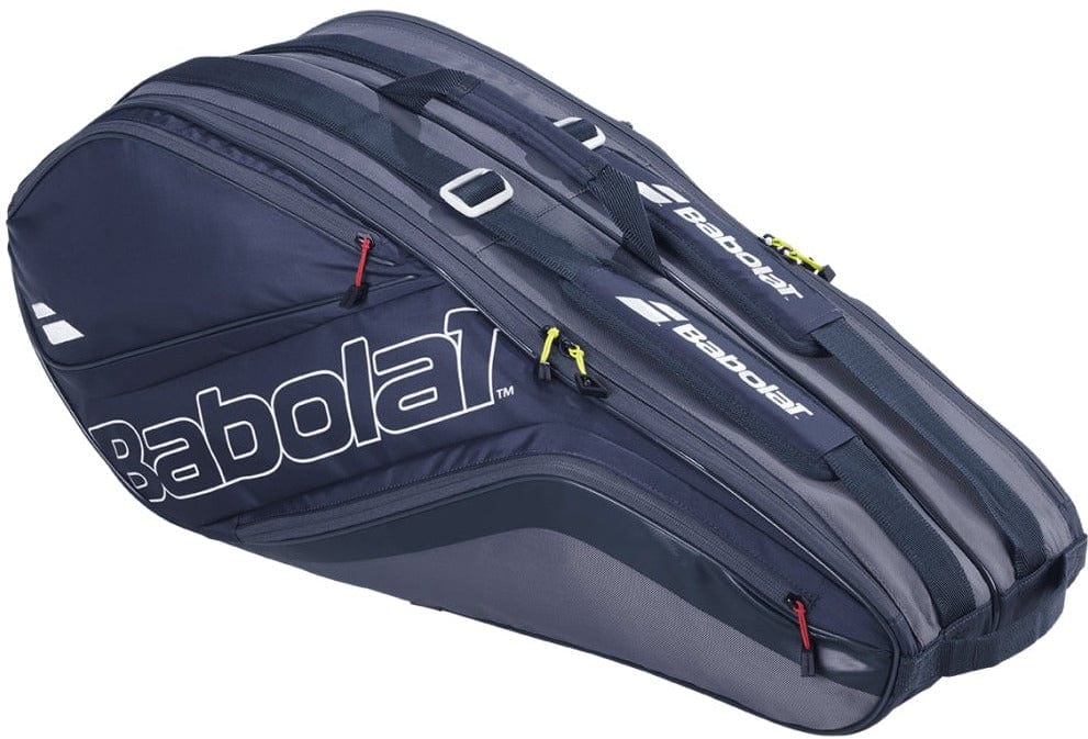 Introducing the Babolat Evo Court L Racket Bag in grey and blue, designed with eco-friendly recycled PET material. This bag features multiple zippered compartments and displays the white Babolat logo on its side. For versatile carrying options, handles and shoulder straps are included.