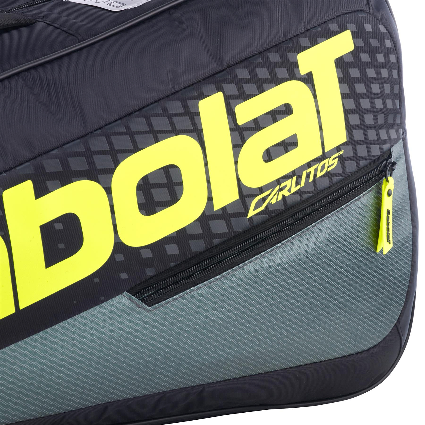 Close-up of the Babolat RH Carlitos Junior 3 Racket Badminton Bag in black and yellow, featuring bold Babolat branding, a small zippered pocket with a yellow pull, and "Carlitos" near the logo—ideal as a kids badminton racket bag.
