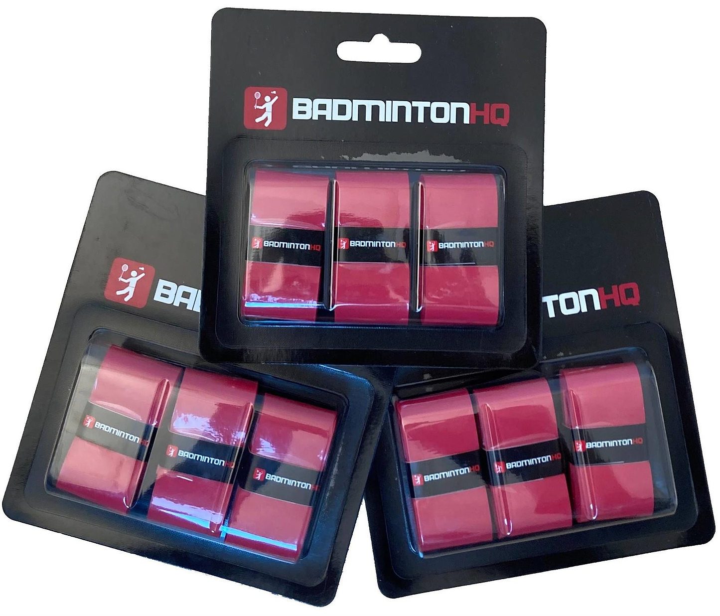 Three packs of BadmintonHQ 3 Pack Badminton Overgrips in red, each pack containing three grips with excellent sweat absorption, are shown overlapped on a white background in black and white BadmintonHQ packaging.