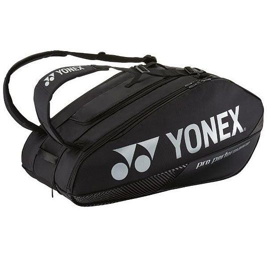 The Yonex 92429EX 9 Racket Pro Badminton Bag - Black is a sleek design featuring multiple compartments and a comfortable shoulder strap. The brand name "Yonex" and its logo are elegantly printed in white on the side, making it perfect for carrying all your essentials.