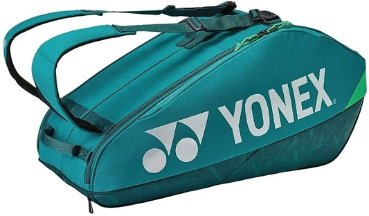 The Yonex 92426EX 6 Racket Pro Badminton Bag in dark green features black straps and a large white Yonex logo, designed to carry up to six racquets and sports gear.