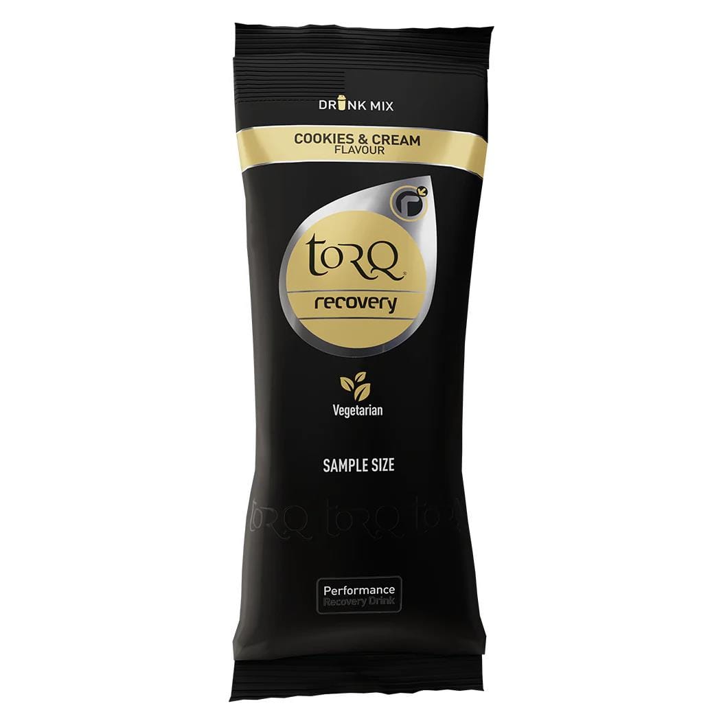 A 50g sachet of Torq Recovery drink mix in cookies and cream flavor features elegant black packaging with a gold and silver logo, emphasizing its post-exercise nutrition benefits and clearly marked as vegetarian.