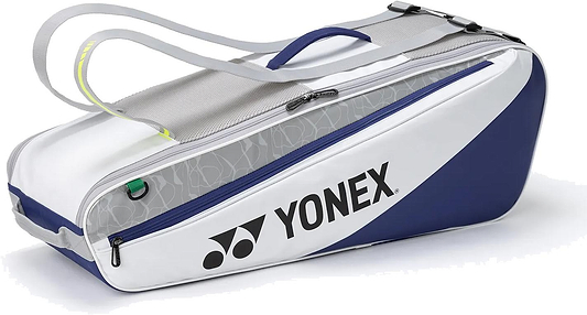 The Yonex BA52526EX Club 6 Racket Badminton Bag in white and blue features zippered compartments and gray straps—ideal for stylishly carrying your gear, with the Yonex logo displayed on the side.