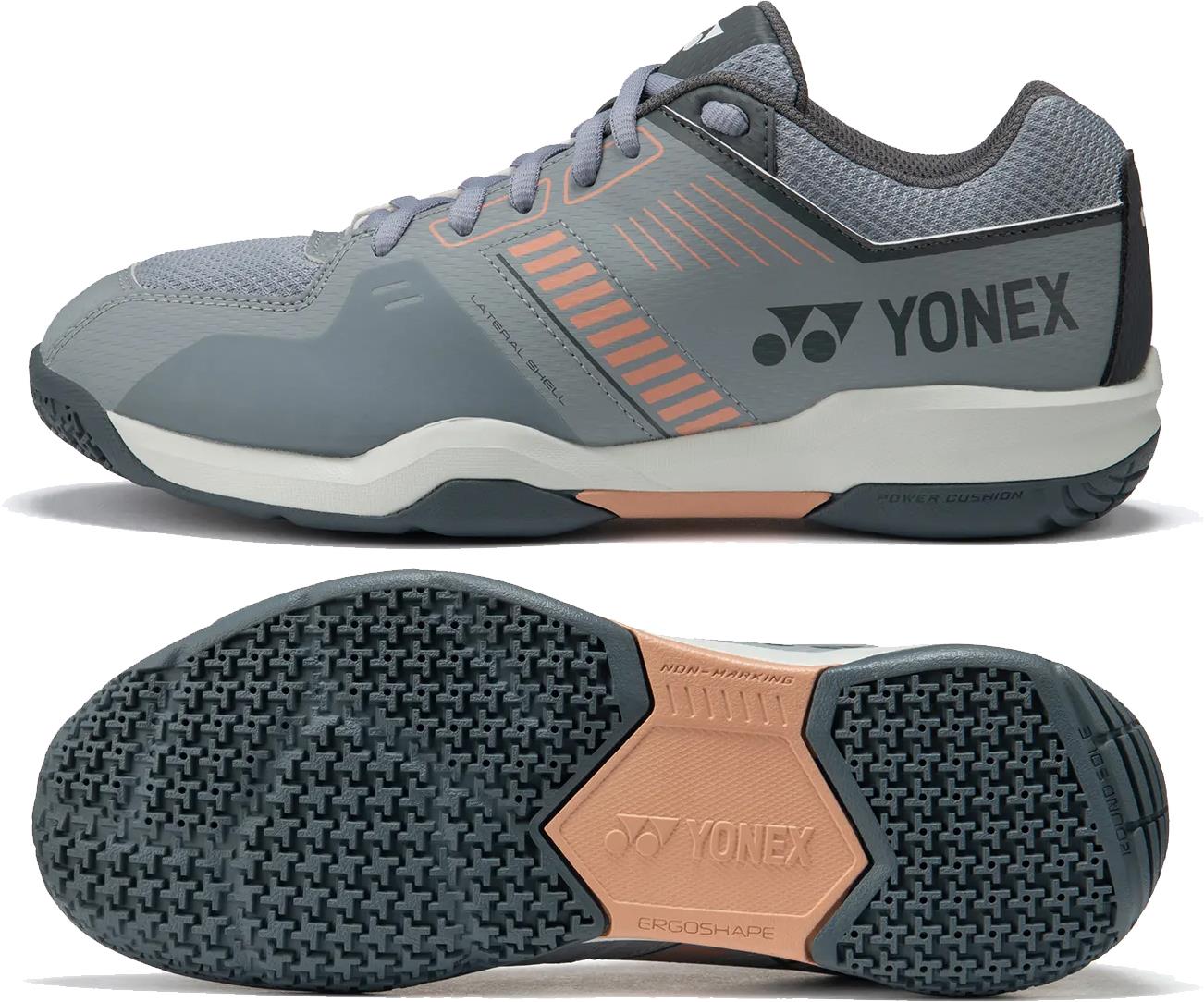 Yonex Strider Flow Unisex Badminton Shoes in light grey feature a mesh upper, cushioned sole, and textured rubber outsole for grip. The Yonex logo and brand name appear on the side and sole.