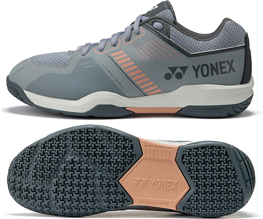 Yonex Strider Flow Unisex Badminton Shoes in light grey feature a mesh upper, cushioned sole, and textured rubber outsole for grip. The Yonex logo and brand name appear on the side and sole.