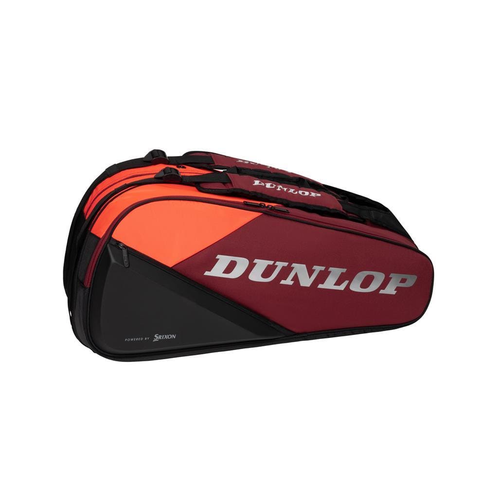 The Dunlop CX Performance 12 Badminton Racket Bag in black and red is perfect for any sports enthusiast. It features the "Dunlop" branding on the side, ergonomic shoulder straps, and multiple compartments for efficient racket storage. This large, divided bag, with orange accents, is ideal even as a tennis bag.
