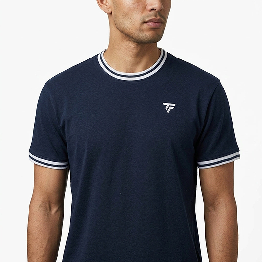 A man wearing a Tecnifibre Team Stretch Mens Badminton T-Shirt in Marine Blue with white trim and a small white chest logo stands against a plain white background.