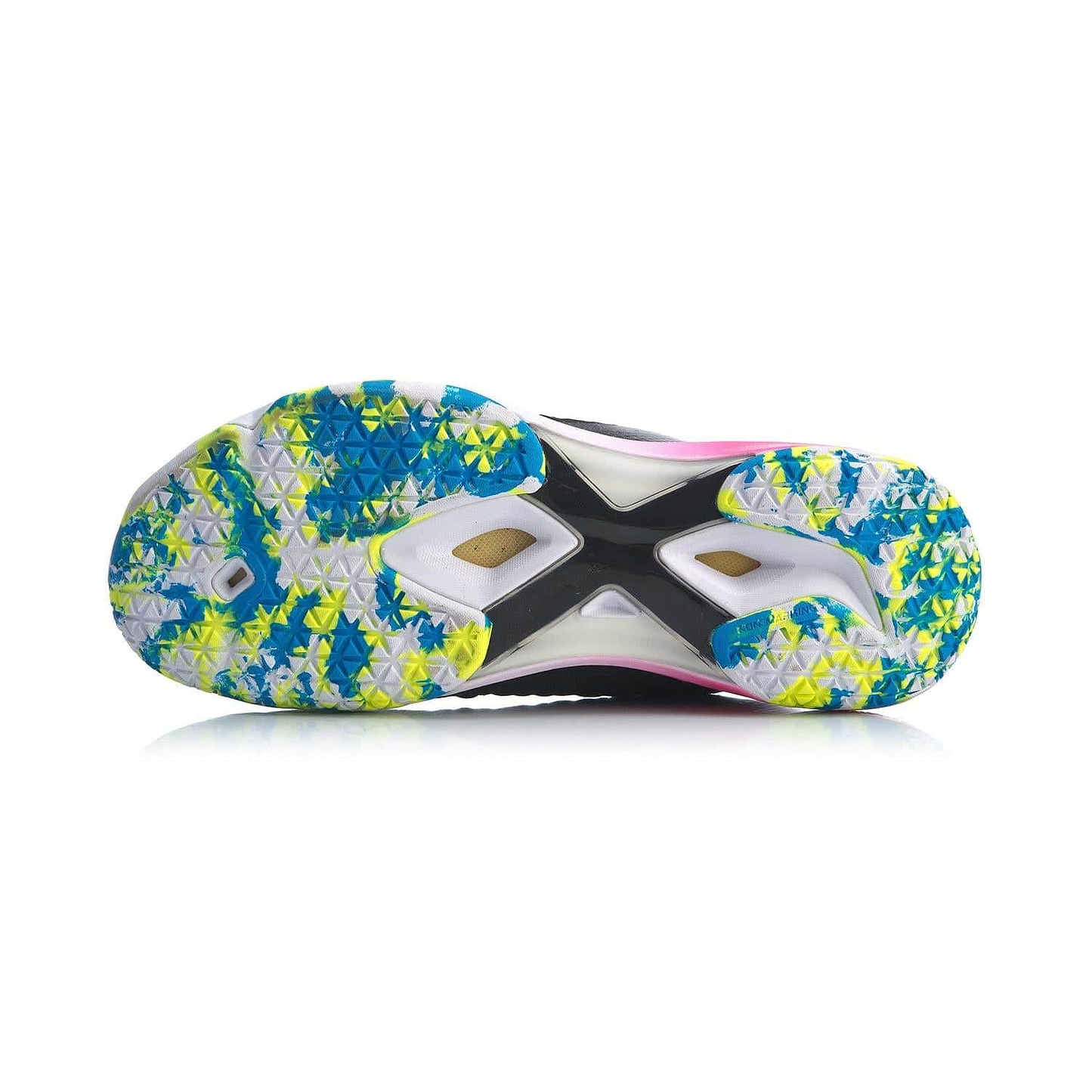 The image highlights the vibrant sole of a Li-Ning Dagger II SE men's badminton shoe in black and pink, displaying a geometric pattern with blue, yellow, and white accents. The design incorporates triangular grips along with a central X-shaped structure in black and white, enhanced by Drive Foam for exceptional performance.