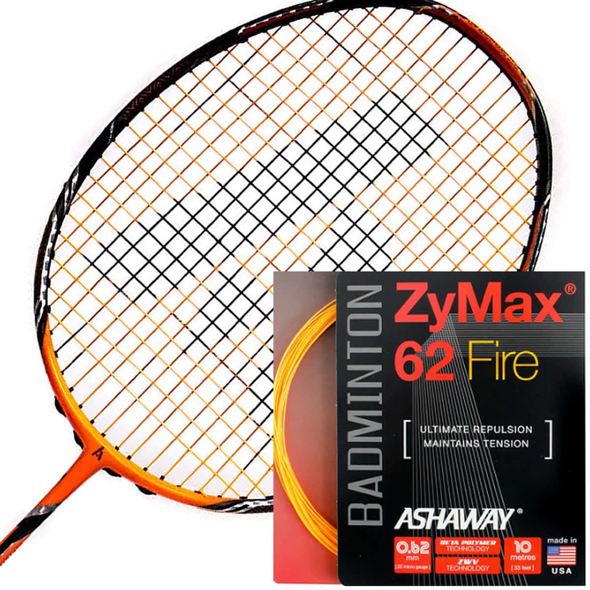 An Ashaway Zymax 62 Fire badminton racket with orange strings rests next to a packet of Ashaway ZyMax 62 Fire string, renowned for its high-performance playability. This packet highlights its maximum repulsion and tension maintenance capabilities and features a sleek black and red design with vibrant orange accents.
