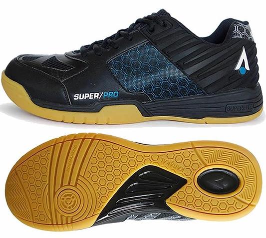 Karakal's Super Pro Indoor Court Badminton Shoes in black feature a blue accent with a side decorated in a honeycomb pattern and a gum-colored sole. From the top, an asymmetric lace system is visible, accompanied by "SUPER/PRO" text. These shoes for indoor courts also boast a unique heel design within their circular tread pattern.