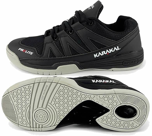 A pair of Karakal KF Pro Lite Badminton Shoes in black, featuring white soles and displaying the brand "Karakal" on the side. These lace-up shoes are equipped with a shock-absorbing gel insole and provide lateral stability with a textured grip pattern on the bottom for enhanced traction.