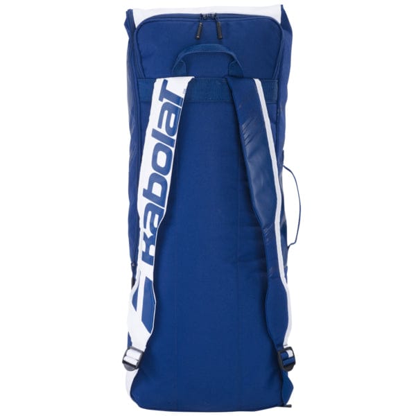 A Babolat Backrack 2 Bag Blue/White lies flat, showcasing its design with white straps. Made from recycled PET, it features a top zipper and prominently displays the Babolat logo on the straps, blending sustainability with style.