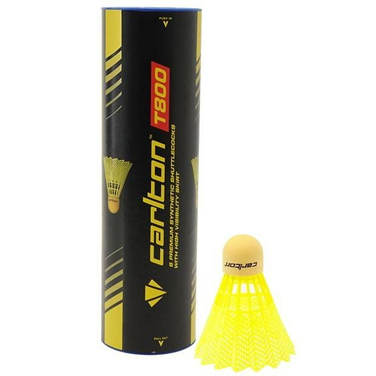 Standing upright is a tube marked "Carlton T800 Yellow Medium Badminton Nylon Shuttles," which accompanies a yellow synthetic shuttlecock featuring a cork tip. The tube features a black and yellow design, ideal for club use, highlighting its durability and exceptional flight quality.