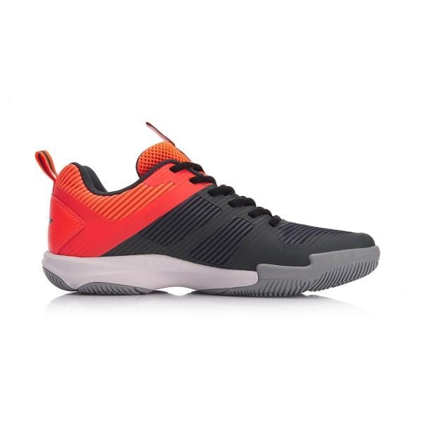 Side view of the trendy Li-Ning Ranger TD Men's Badminton Shoe, which features a black and red upper complemented by a grey biometric outsole. This shoe boasts a textured design, breathable construction, and a convenient pull tab on the heel for easy wearability.