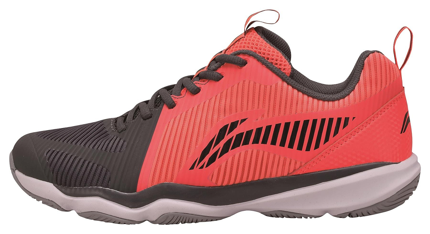 Introducing the Li-Ning Ranger TD Men's Badminton Shoes in Red and Black, featuring a textured design with breathable elements and a contrasting white sole. These sneakers are adorned with diagonal line patterns on the sides and finished with a sleek black tongue and laces for added style.