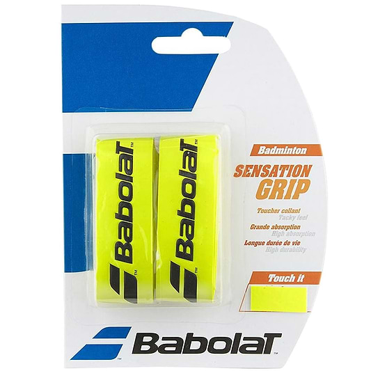 The packaging for the Babolat Badminton Grip Sensation - Yellow - 2 Pack includes two tacky yellow grips prominently featuring the black Babolat logo. This product is perfect for match play, emphasizing benefits such as "great absorption" and "long life durability.