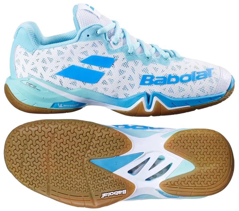 The Babolat Shadow 4 Womens Badminton Shoes - White Lagoon are shown from the side and bottom, highlighting a textured brown sole, blue accents, and the Babolat logo.