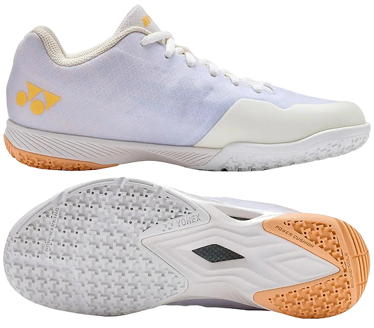 The Yonex Power Cushion Aerus Z2 Women’s Badminton Shoes in white and orange feature a textured sole for grip, white laces, light yellow accents, and Yonex logos on the side and tongue.