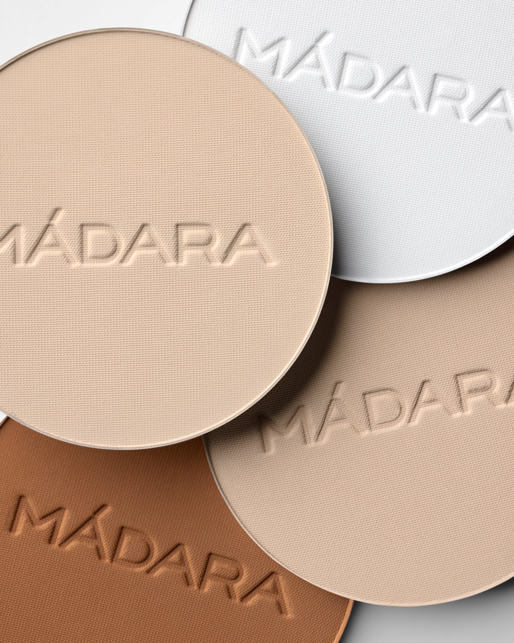 Texture close-up of MÁDARA Organic Skincare soft silk mineral powder textures A6801 �swatch demonstrates consistency and finish.