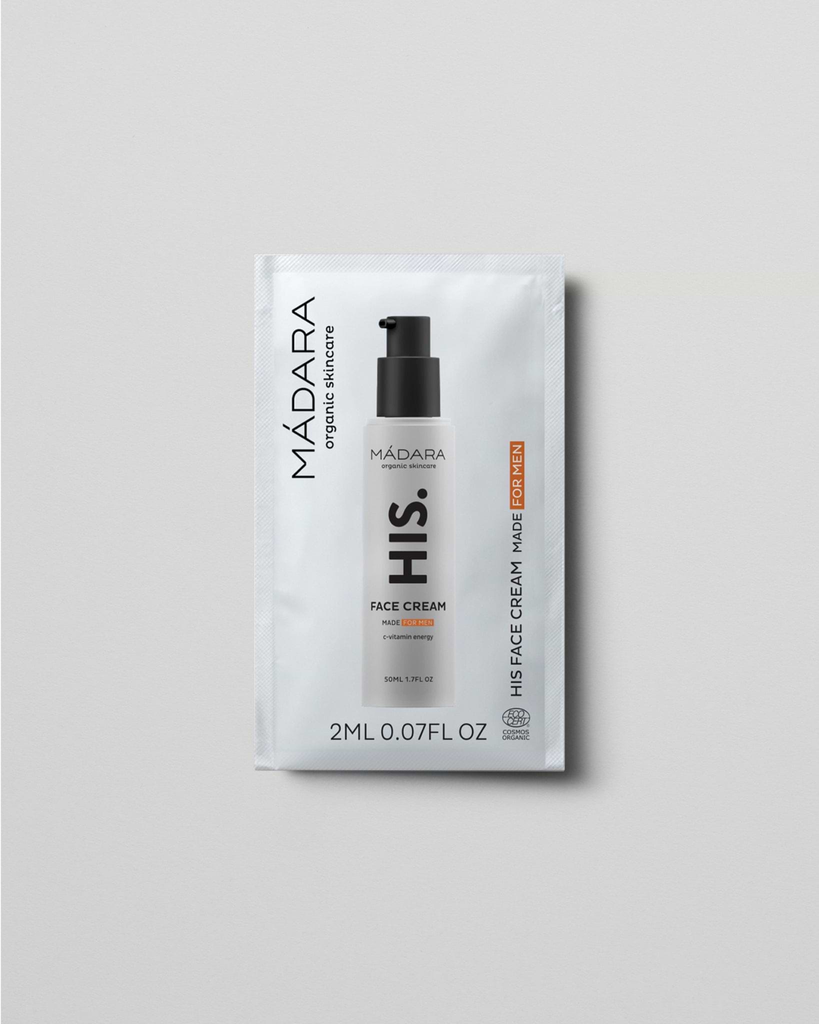Model wearing MÁDARA Organic Skincare face cream for men 2ml sample SC5003 2 face cream on skin; close-up portrait shows natural application results.