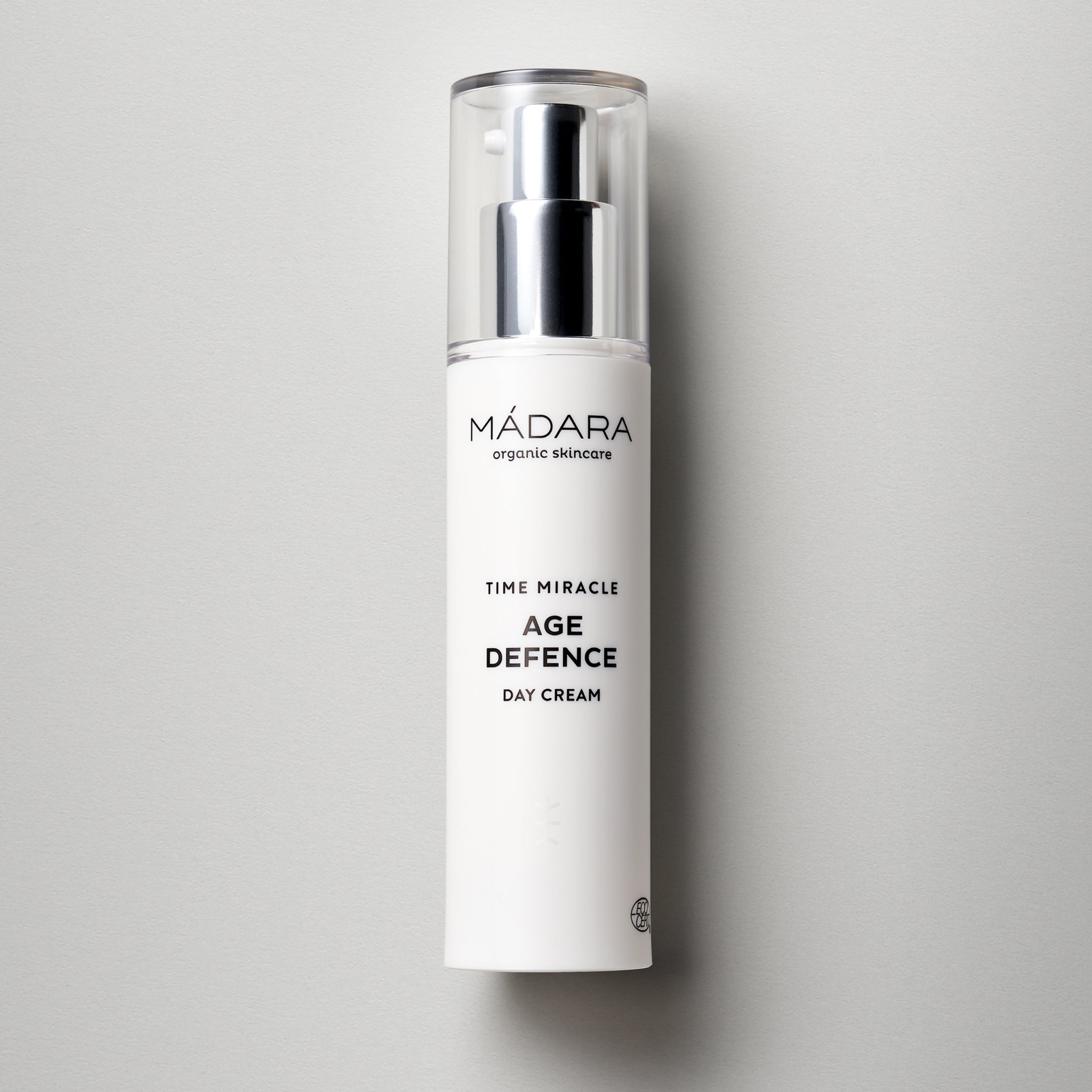 50 ml pump bottle of Madara Organic Skincare Time Miracle Age Defence Day cream with cap on a grey background