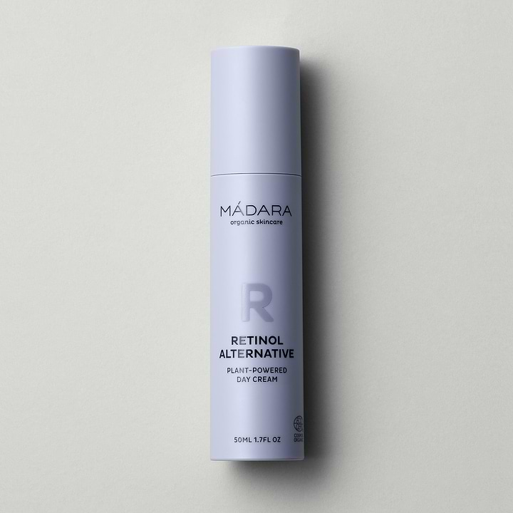 A 50 ml pump bottle of Madara Organic Skincare Retinol Alternative Plant-Powered Day Cream with cap on a grey background