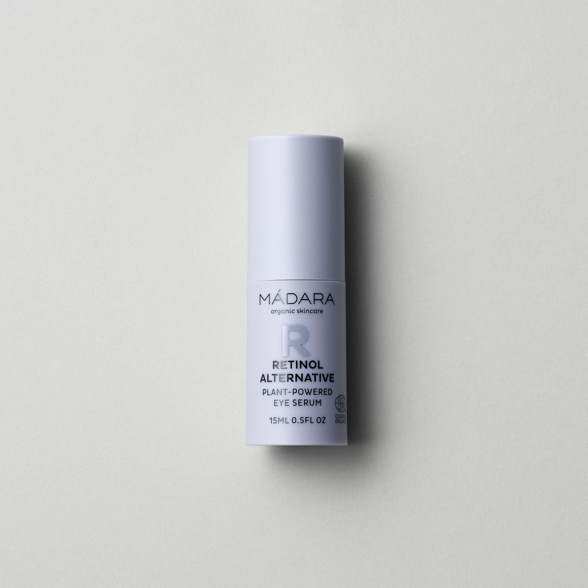 A 15 ml pump bottle of Madara Organic Skincare Retinol Alternative Plant-Powered Eye Serum with cap on a grey background