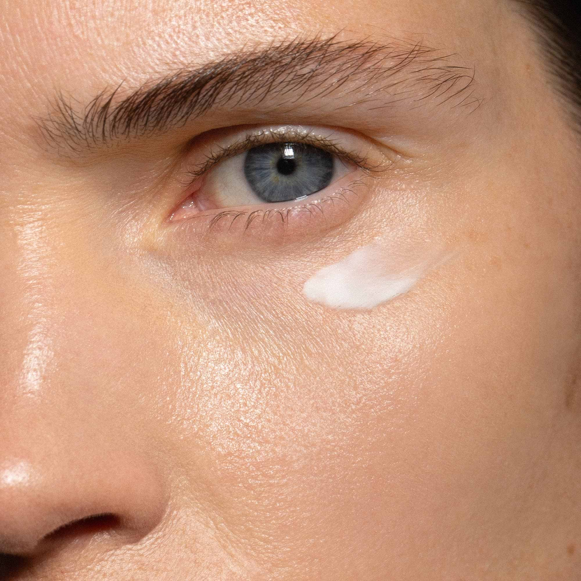 Madara Cosmetics Retinol Alternative Plant-Powered Eye Cream applied on a woman's skin.