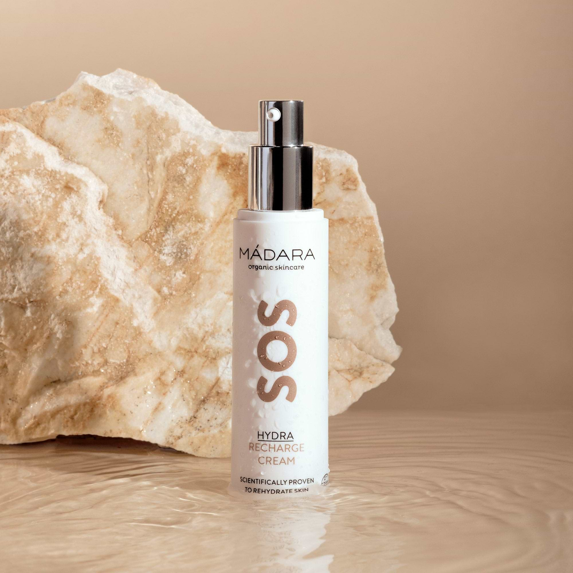 Madara Organic Skincare SOS Hydra Recharge Face Cream 50 ml pump bottle with no cap next to a marble-like rock