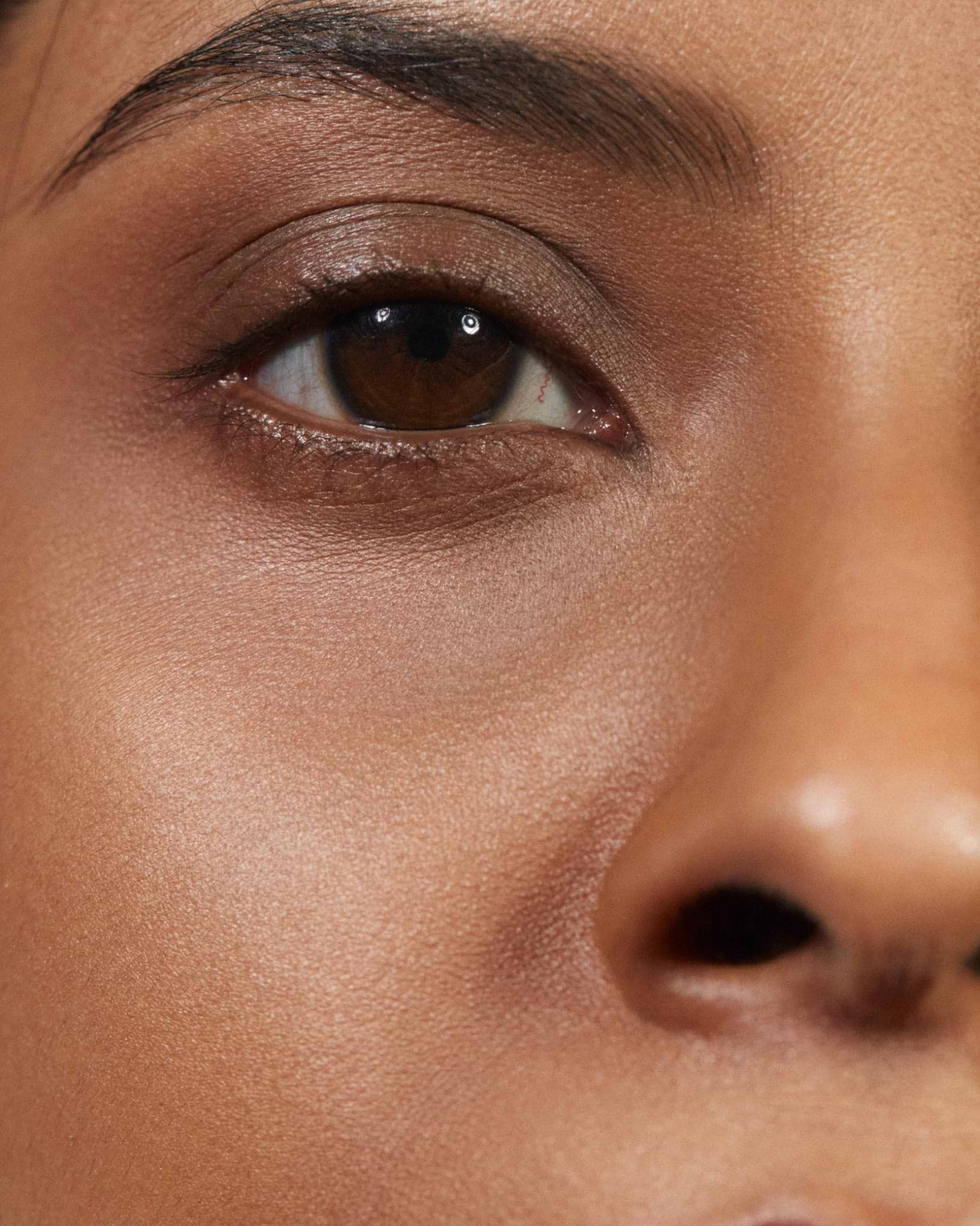 Model wearing MÁDARA Organic Skincare the concealer amber on A6115 concealer on skin; close-up portrait shows natural application results.