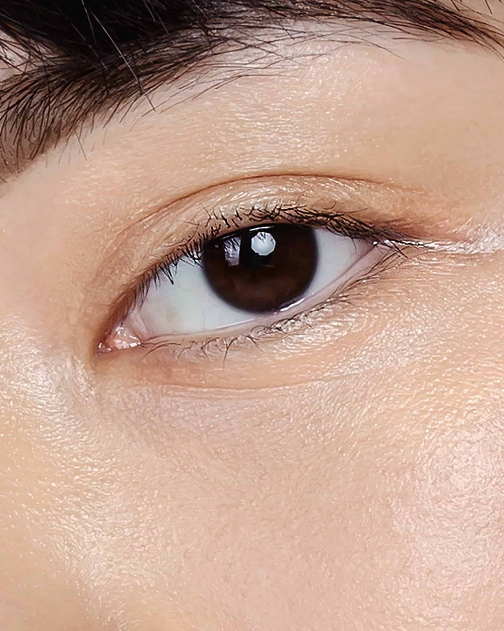 Model wearing MÁDARA Organic Skincare the concealer honey on A6102 concealer on skin; close-up portrait shows natural application results.