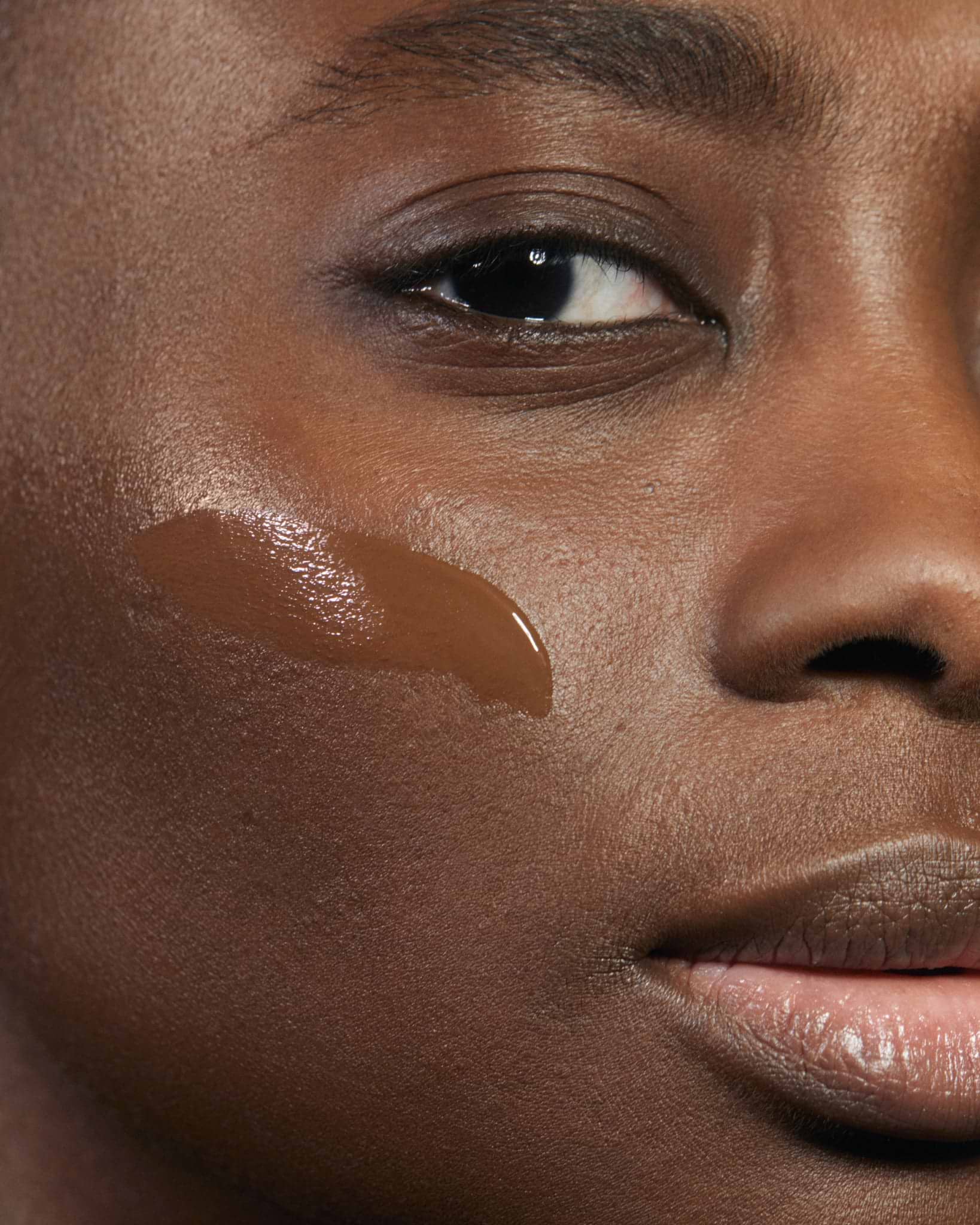 Model wearing MÁDARA Organic Skincare skinonym foundation chestnut on A6097 foundation on skin; close-up portrait shows natural application results.