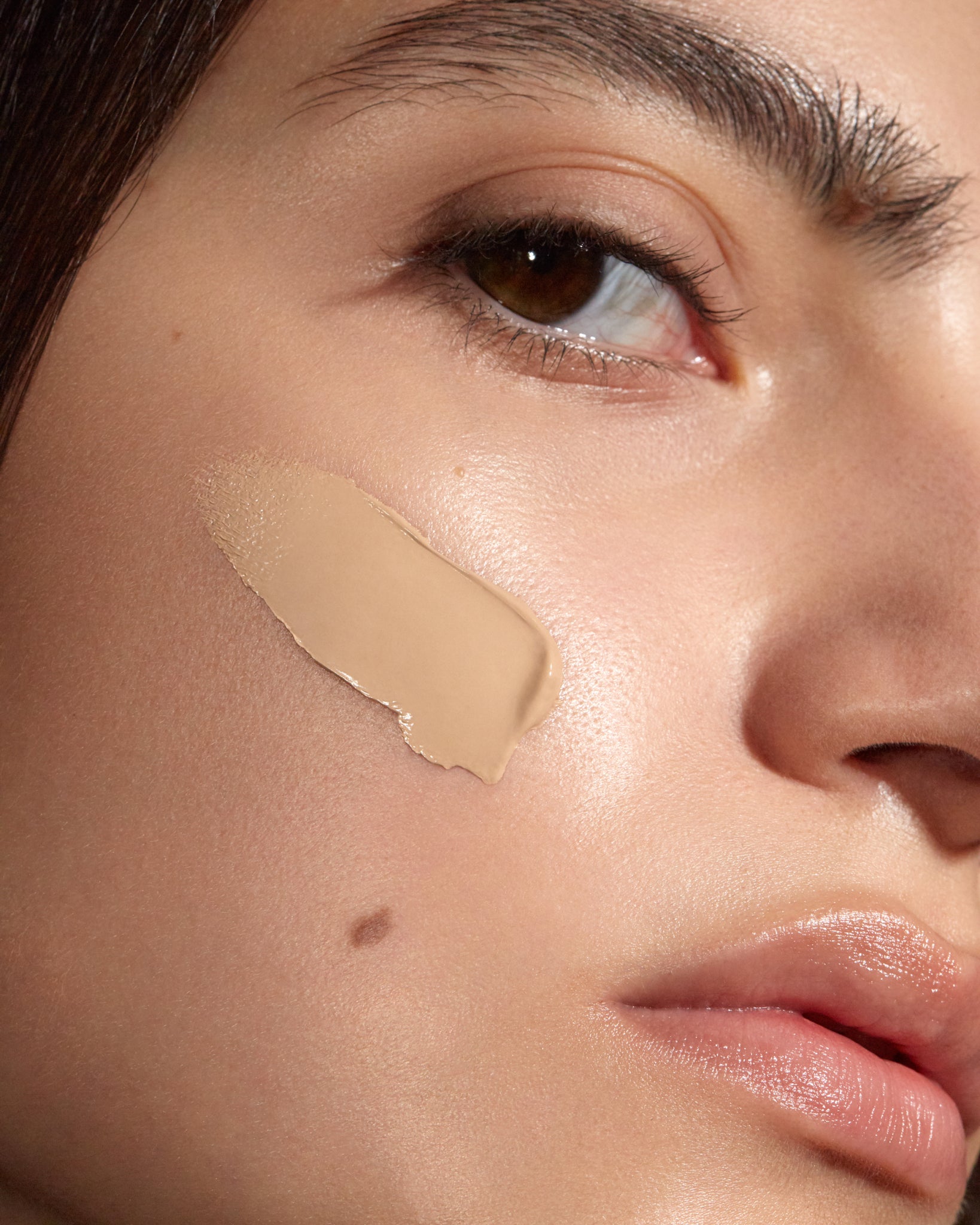 Model wearing MÁDARA Organic Skincare true beige foundation on A6084 foundation on skin; close-up portrait shows natural application results.