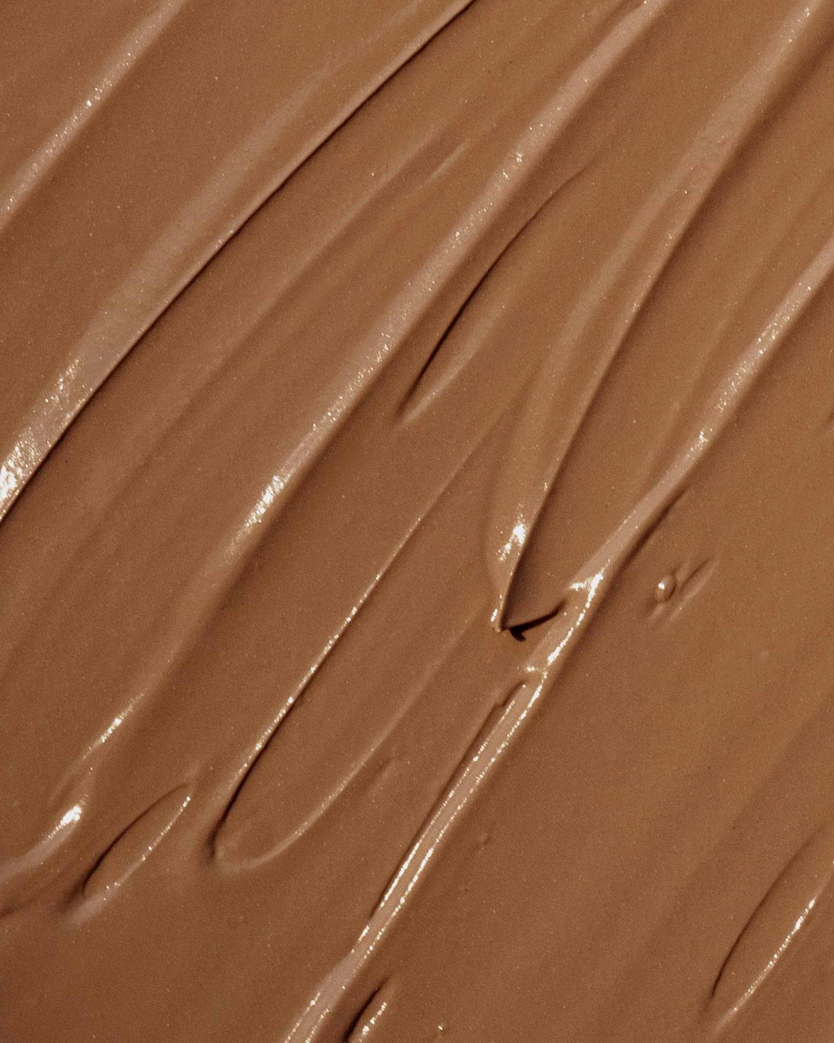 Texture close-up of MÁDARA Organic Skincare cc cream tan A3413 face cream �swatch demonstrates consistency and finish.