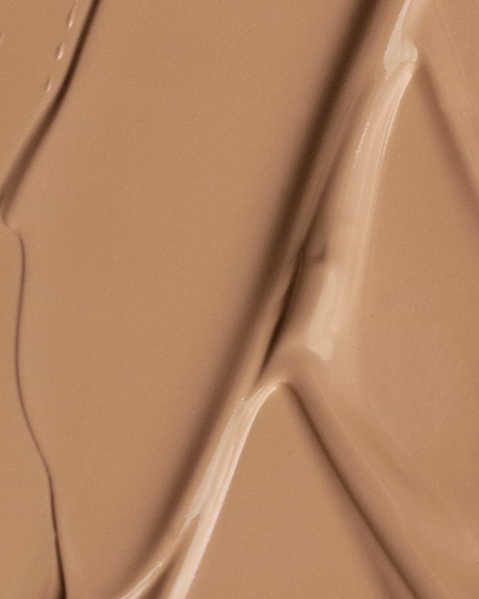 Texture close-up of MÁDARA Organic Skincare the concealer pine A6114 concealer �swatch demonstrates consistency and finish.
