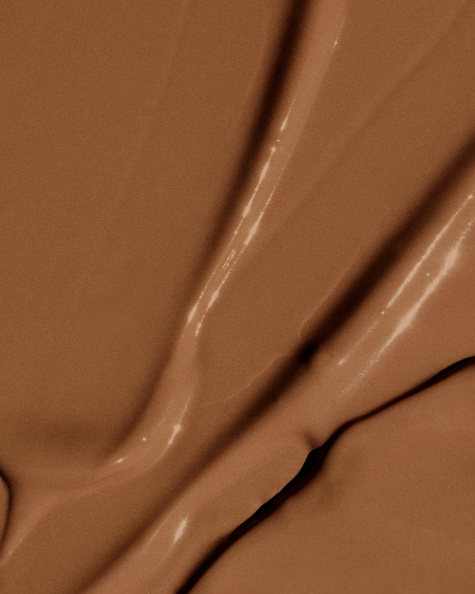 Texture close-up of MÁDARA Organic Skincare the concealer rich soil A6116 concealer �swatch demonstrates consistency and finish.