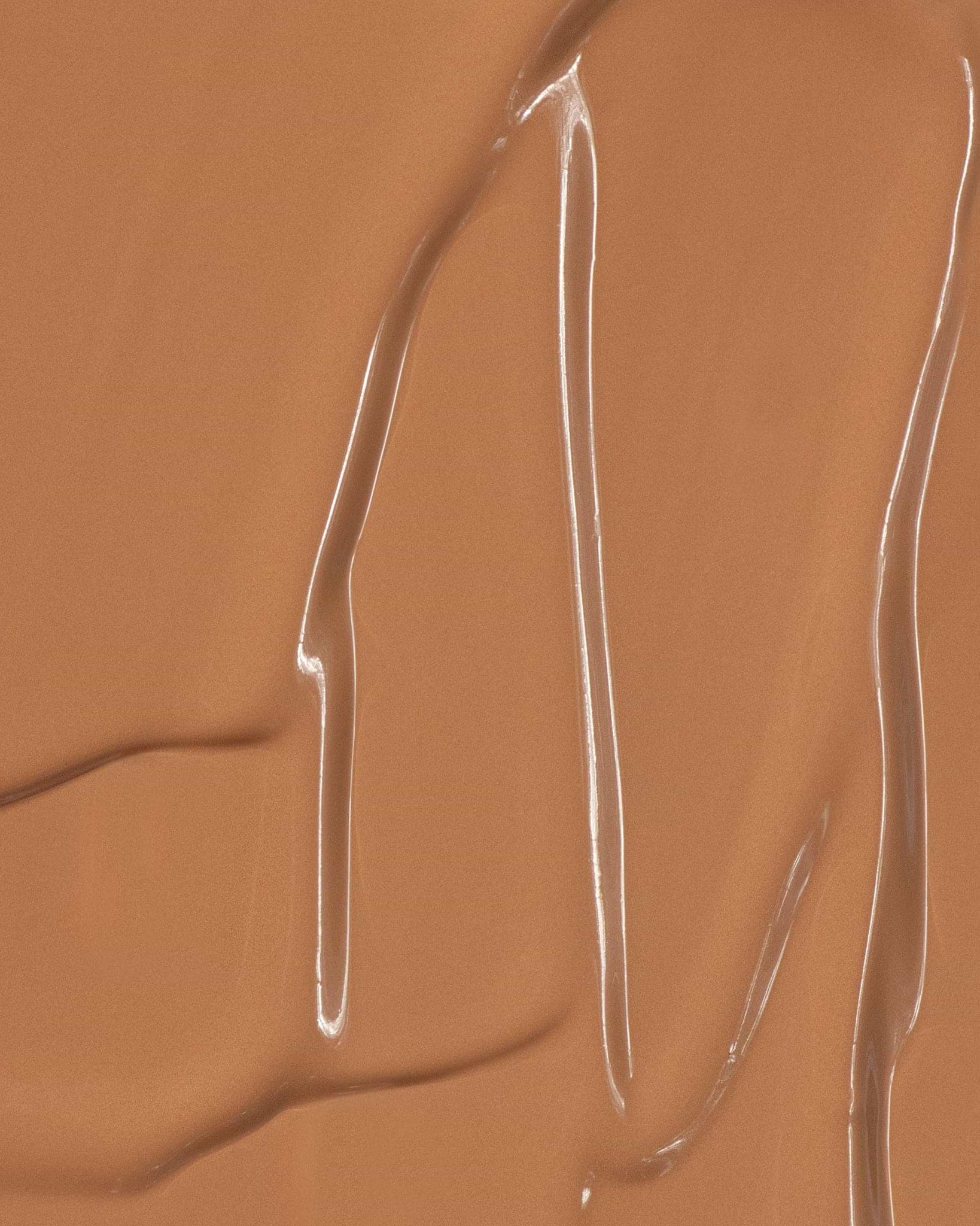 Texture close-up of MÁDARA Organic Skincare skin equal foundation caramel A6063 foundation �swatch demonstrates consistency and finish.