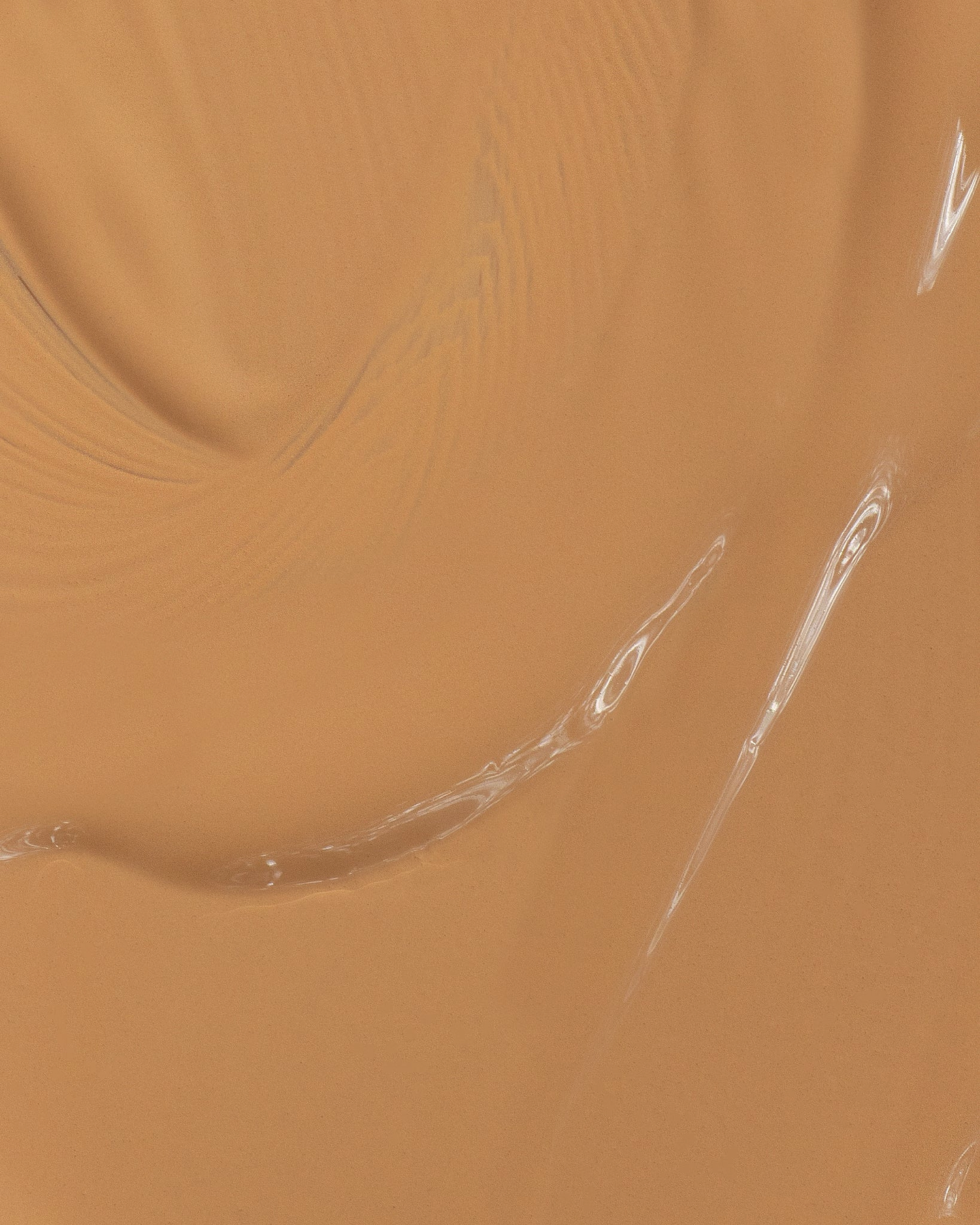 Texture close-up of MÁDARA Organic Skincare skin equal foundation olive A6061 foundation �swatch demonstrates consistency and finish.