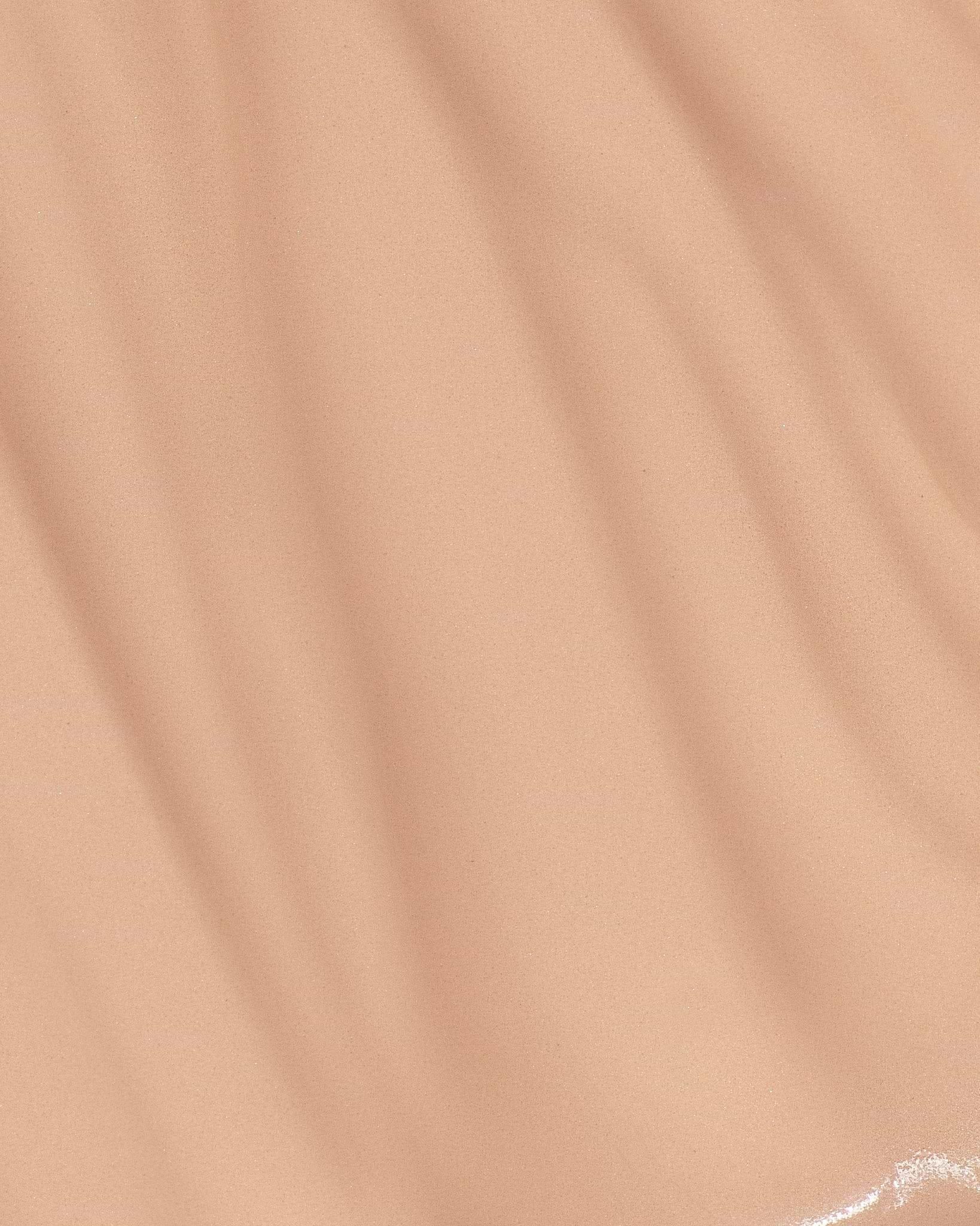 Texture close-up of MÁDARA Organic Skincare skin equal foundation rose ivory A6055 foundation �swatch demonstrates consistency and finish.