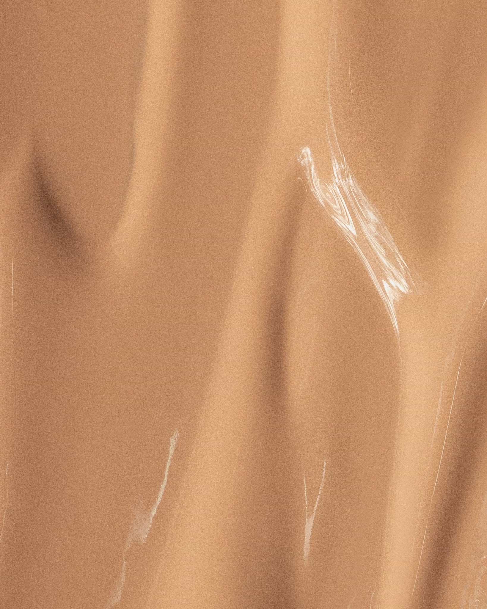 Texture close-up of MÁDARA Organic Skincare skin equal golden sand A6059 �swatch demonstrates consistency and finish.