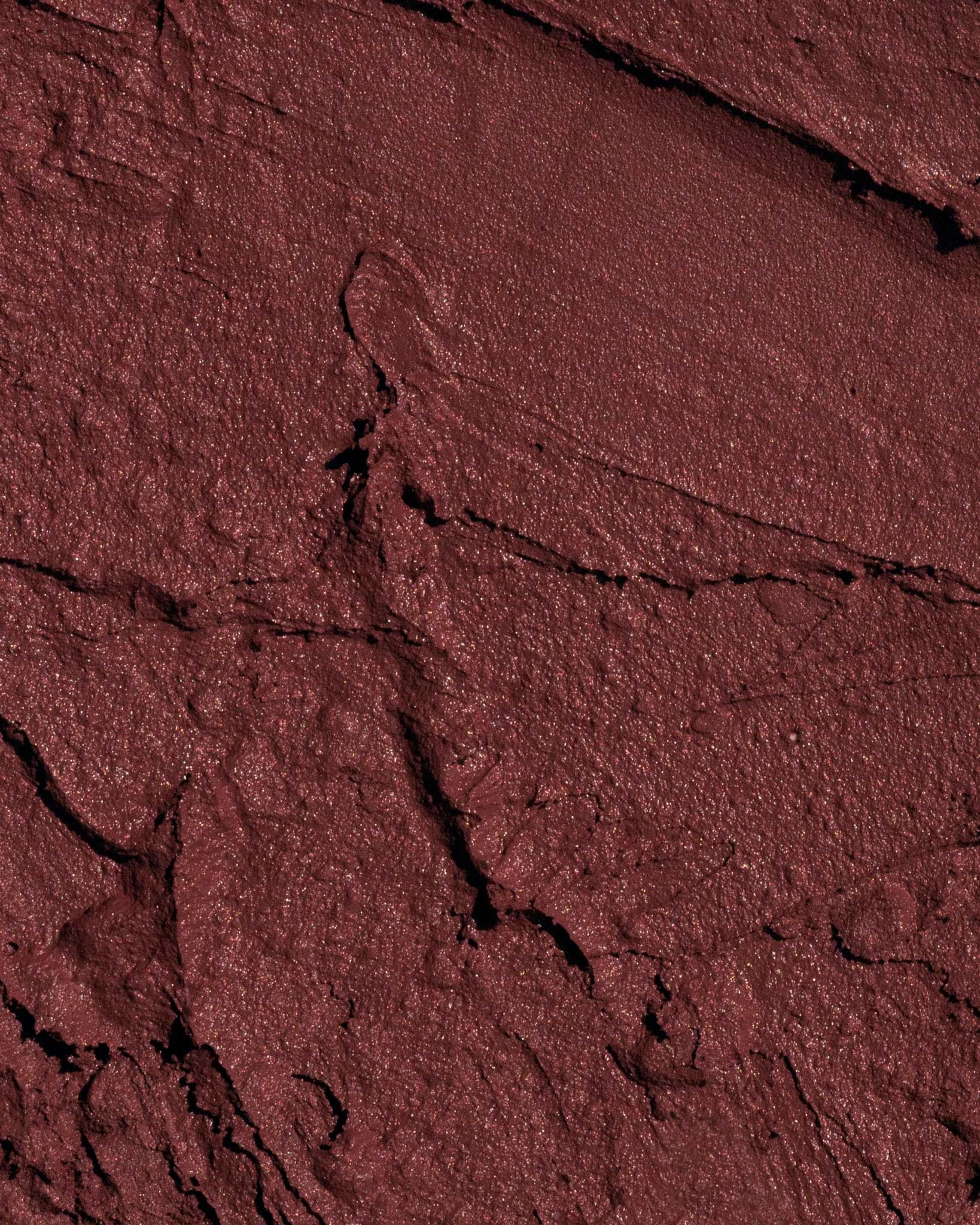 Texture close-up of MÁDARA Organic Skincare velvet wear dark nude A6305 �swatch demonstrates consistency and finish.